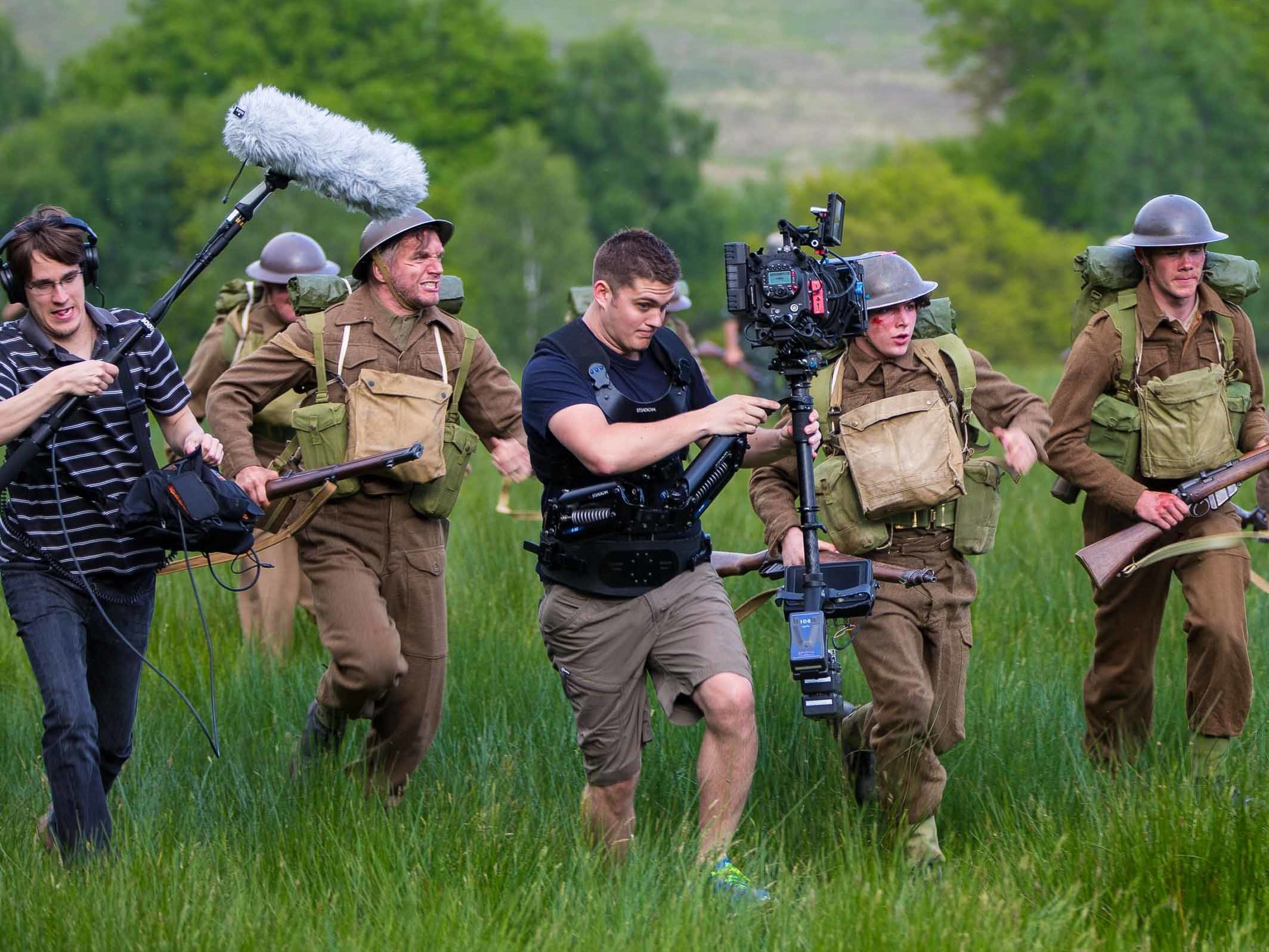 Film crew filming a scene with actors during a professional production.
