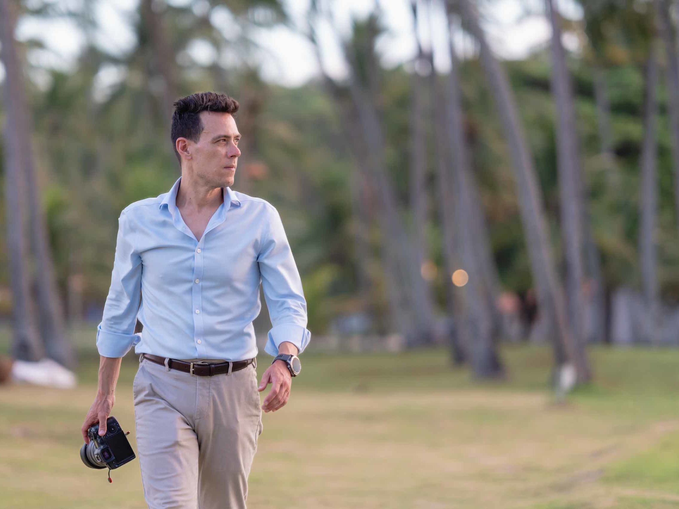 Matt Hodgkin, wedding photographer, walking with camera during a destination wedding.